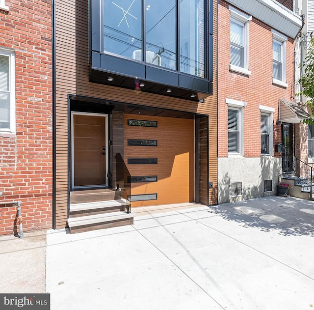 entrance to property with brick siding