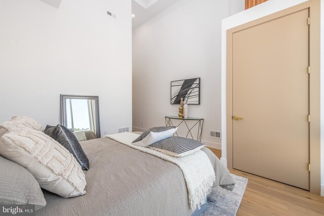 217 Tasker St, Philadelphia, PA 19148 - bedroom featuring visible vents, light wood-style flooring, and a towering ceiling