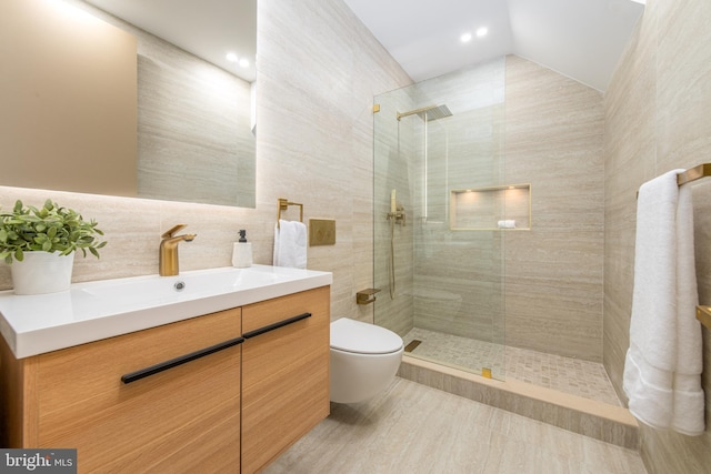 217 Tasker St, Philadelphia, PA 19148 - full bath with a walk in shower, lofted ceiling, toilet, vanity, and tile walls