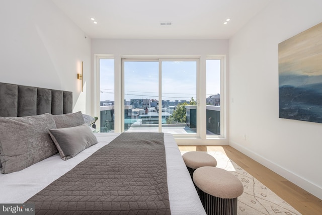 217 Tasker St, Philadelphia, PA 19148 - bedroom with visible vents, baseboards, wood finished floors, access to exterior, and recessed lighting