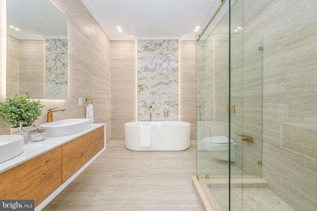 217 Tasker St, Philadelphia, PA 19148 - bathroom featuring a sink, tile walls, a freestanding bath, a shower stall, and double vanity