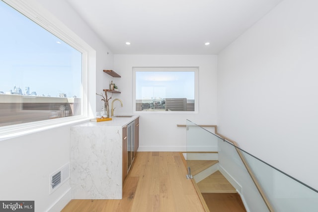 217 Tasker St, Philadelphia, PA 19148 - kitchen with recessed lighting, a sink, visible vents, open shelves, and light wood finished floors