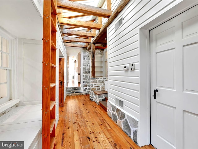 hall with visible vents and light wood-style floors