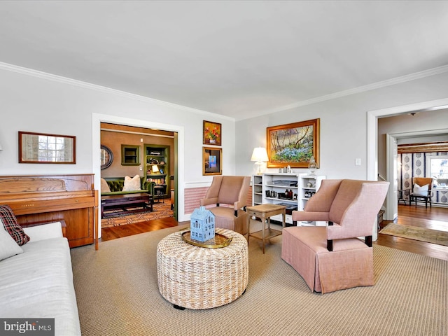 living room featuring crown molding and wood finished floors