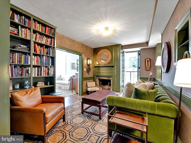 living area featuring wood finished floors and a fireplace