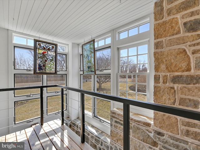 unfurnished sunroom with wood ceiling