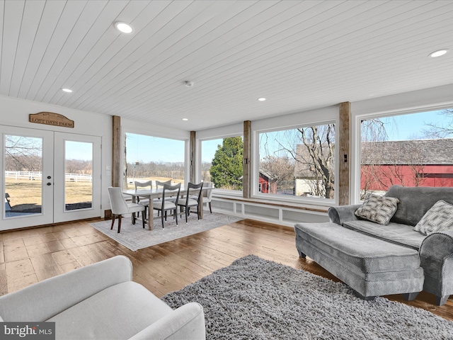 living room with recessed lighting, wood-type flooring, and plenty of natural light