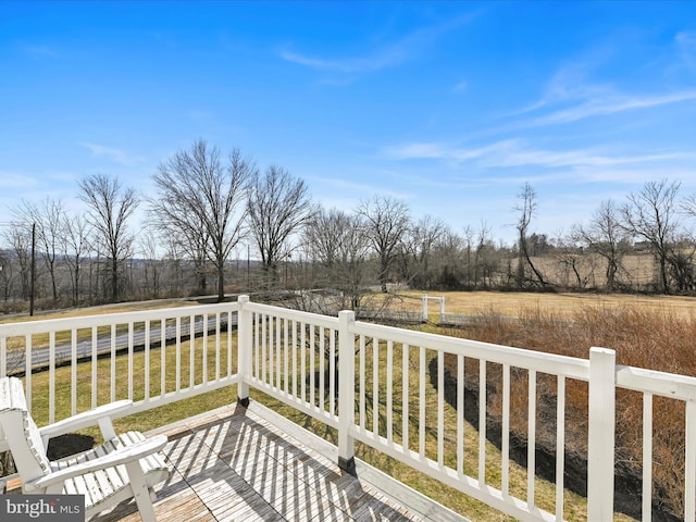 wooden terrace featuring a rural view