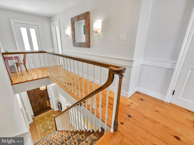 stairs with hardwood / wood-style flooring