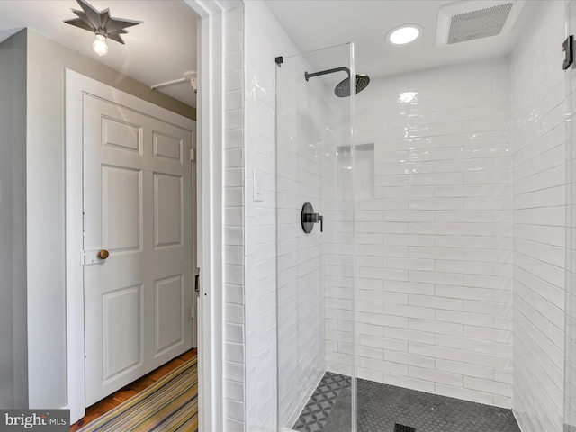 bathroom with visible vents and a shower stall