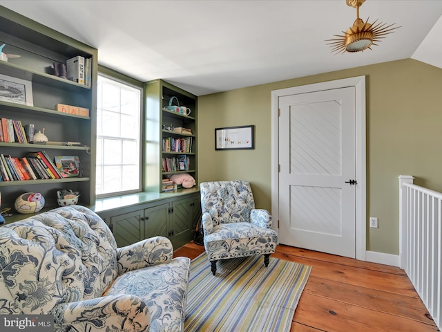 living area featuring light wood-type flooring and vaulted ceiling