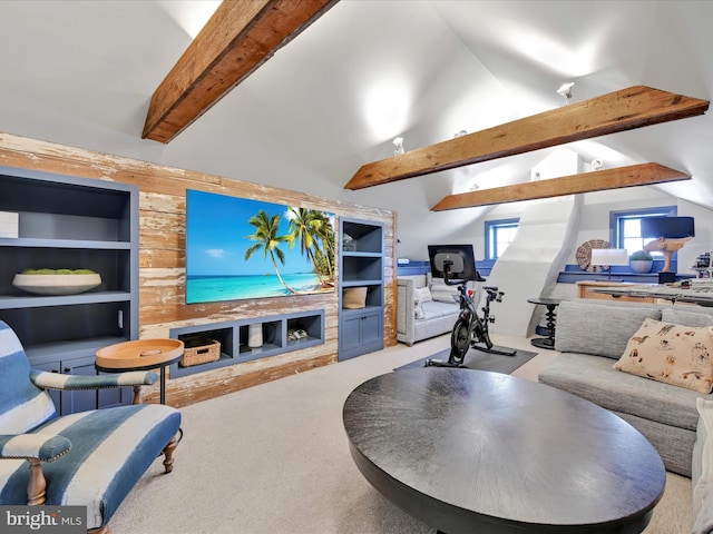 carpeted living room featuring built in features and vaulted ceiling with beams