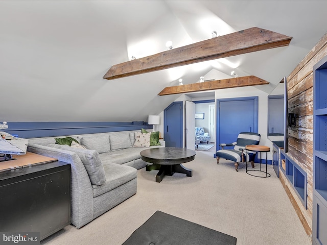 living area with lofted ceiling with beams and carpet floors