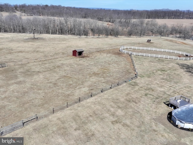 birds eye view of property with a rural view