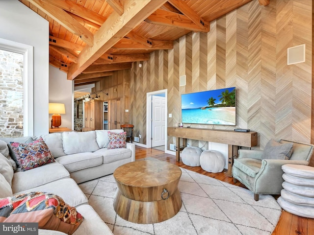 living room with beamed ceiling, wood ceiling, and wood finished floors