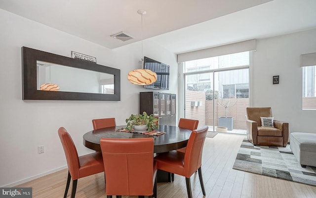 dining space featuring plenty of natural light, visible vents, and wood finished floors