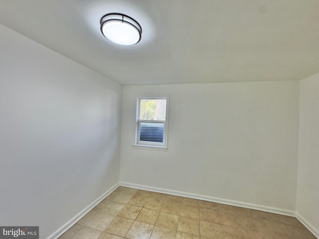 spare room featuring baseboards