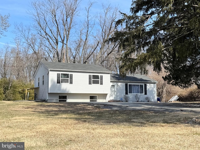 tri-level home with a front yard