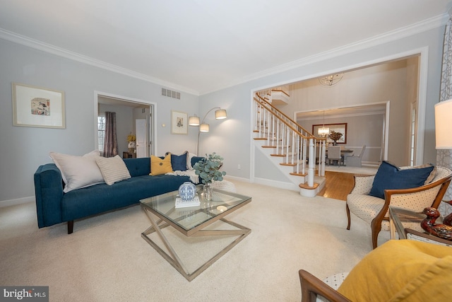 carpeted living area featuring crown molding, visible vents, baseboards, stairway, and an inviting chandelier