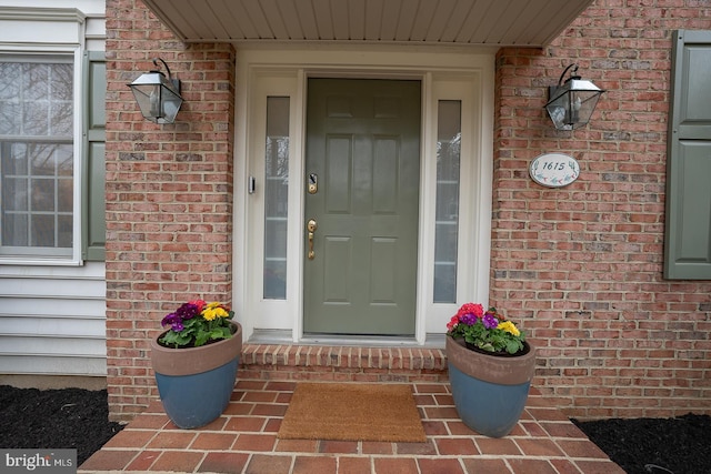 view of exterior entry with brick siding