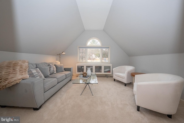 living area featuring carpet and lofted ceiling