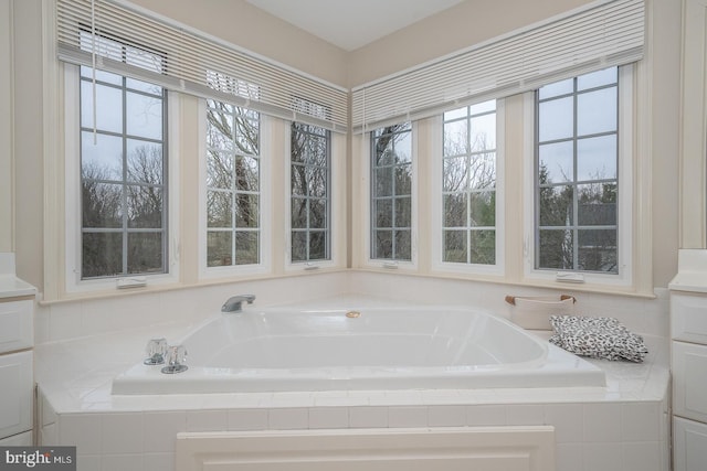 full bathroom with a garden tub and plenty of natural light