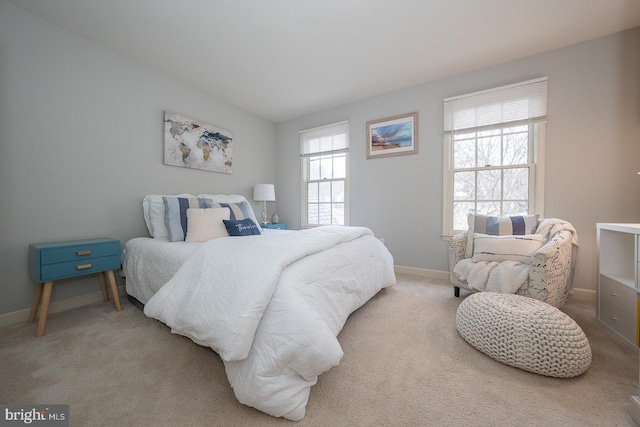 carpeted bedroom featuring baseboards