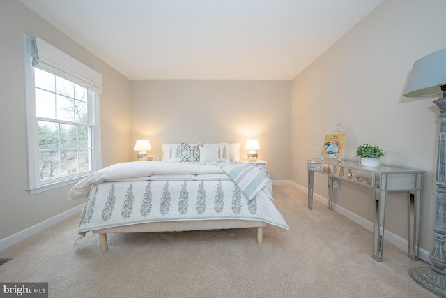 bedroom featuring light carpet, visible vents, and baseboards