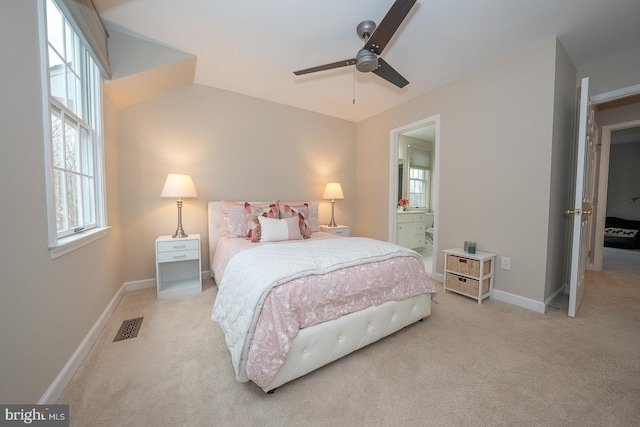 carpeted bedroom featuring baseboards, visible vents, a ceiling fan, connected bathroom, and vaulted ceiling