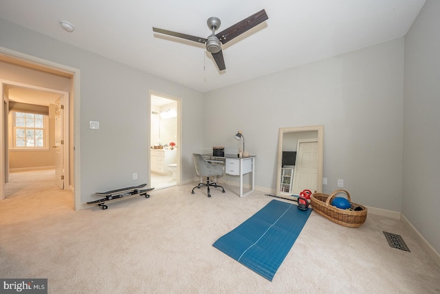 exercise area featuring carpet, visible vents, ceiling fan, and baseboards