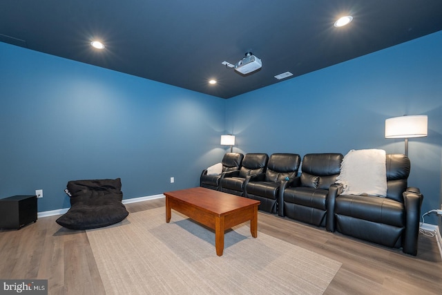 home theater with recessed lighting, wood finished floors, visible vents, and baseboards