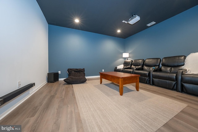 home theater room featuring recessed lighting, visible vents, baseboards, and wood finished floors