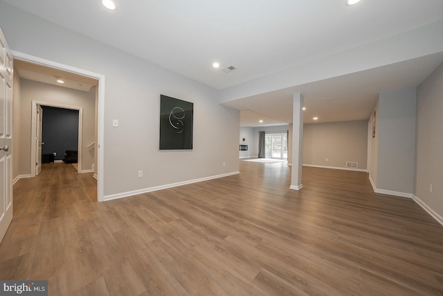 unfurnished living room with recessed lighting, baseboards, and light wood finished floors