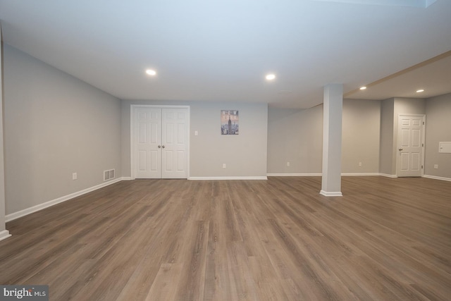 finished below grade area featuring visible vents, baseboards, wood finished floors, and recessed lighting