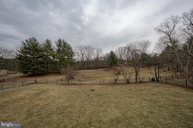 view of yard featuring fence and a rural view