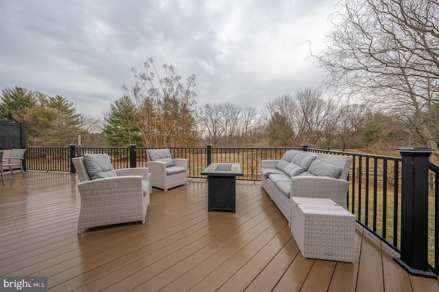 wooden deck with an outdoor living space