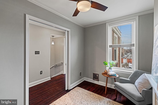 living area featuring baseboards, visible vents, ceiling fan, ornamental molding, and dark wood-style flooring