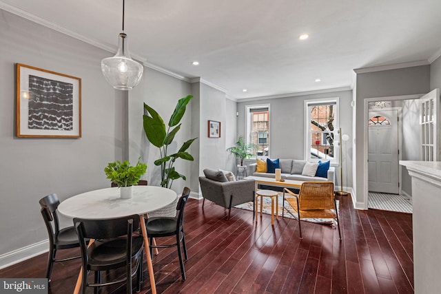 dining room with dark wood-type flooring, recessed lighting, crown molding, and baseboards