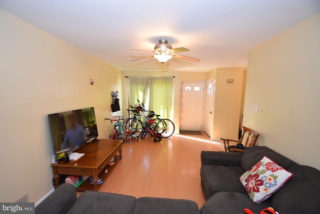 living room with ceiling fan and light hardwood / wood-style floors