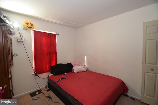 bedroom featuring light colored carpet