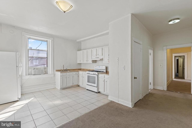 kitchen with white appliances, a sink, white cabinetry, and under cabinet range hood