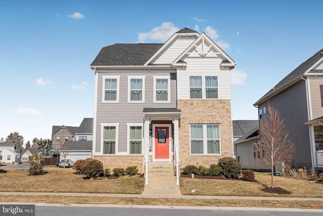 1603 Trotter St, Frederick, MD 21702 - view of front facade featuring brick siding, a front lawn, and roof with shingles