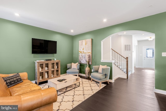 1603 Trotter St, Frederick, MD 21702 - living room with arched walkways, dark wood-style flooring, stairs, and recessed lighting