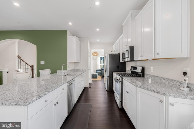 1603 Trotter St, Frederick, MD 21702 - kitchen with appliances with stainless steel finishes, a peninsula, dark wood finished floors, white cabinetry, and recessed lighting