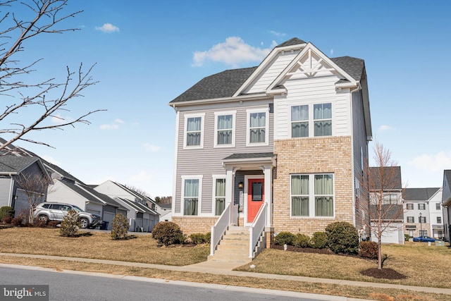 1603 Trotter St, Frederick, MD 21702 - view of front of house with brick siding, a front lawn, a shingled roof, and a residential view