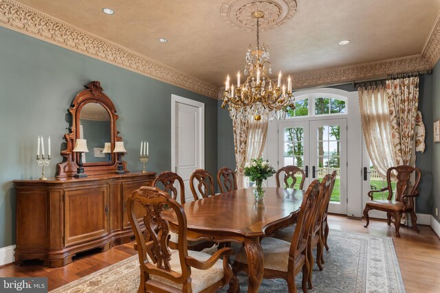 938 Old County Rd, Severna Park, MD 21146 - dining space with a chandelier, ornamental molding, french doors, and light wood-style flooring
