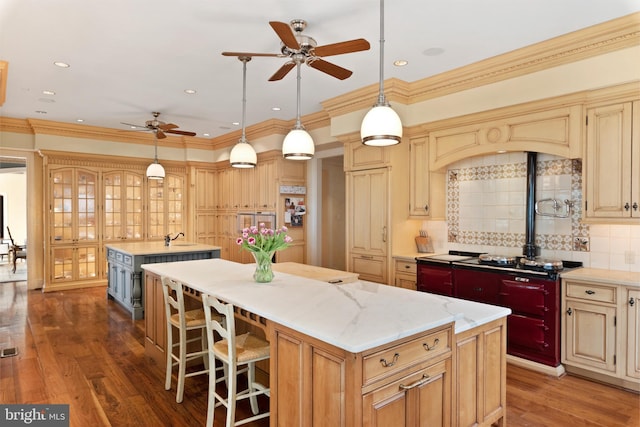 938 Old County Rd, Severna Park, MD 21146 - kitchen with ceiling fan, black stovetop, wood finished floors, tasteful backsplash, and a kitchen island