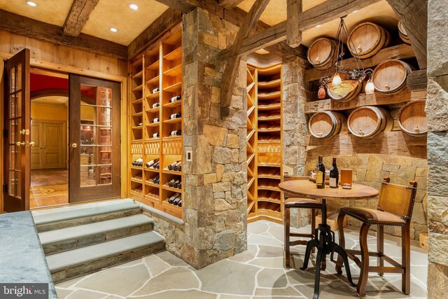 938 Old County Rd, Severna Park, MD 21146 - wine cellar with stone flooring, arched walkways, built in features, recessed lighting, and beamed ceiling