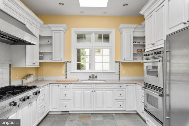 938 Old County Rd, Severna Park, MD 21146 - kitchen with stainless steel appliances, open shelves, a skylight, and a sink