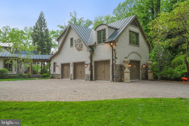 938 Old County Rd, Severna Park, MD 21146 - view of front of house with stone siding, decorative driveway, stucco siding, a standing seam roof, and metal roof